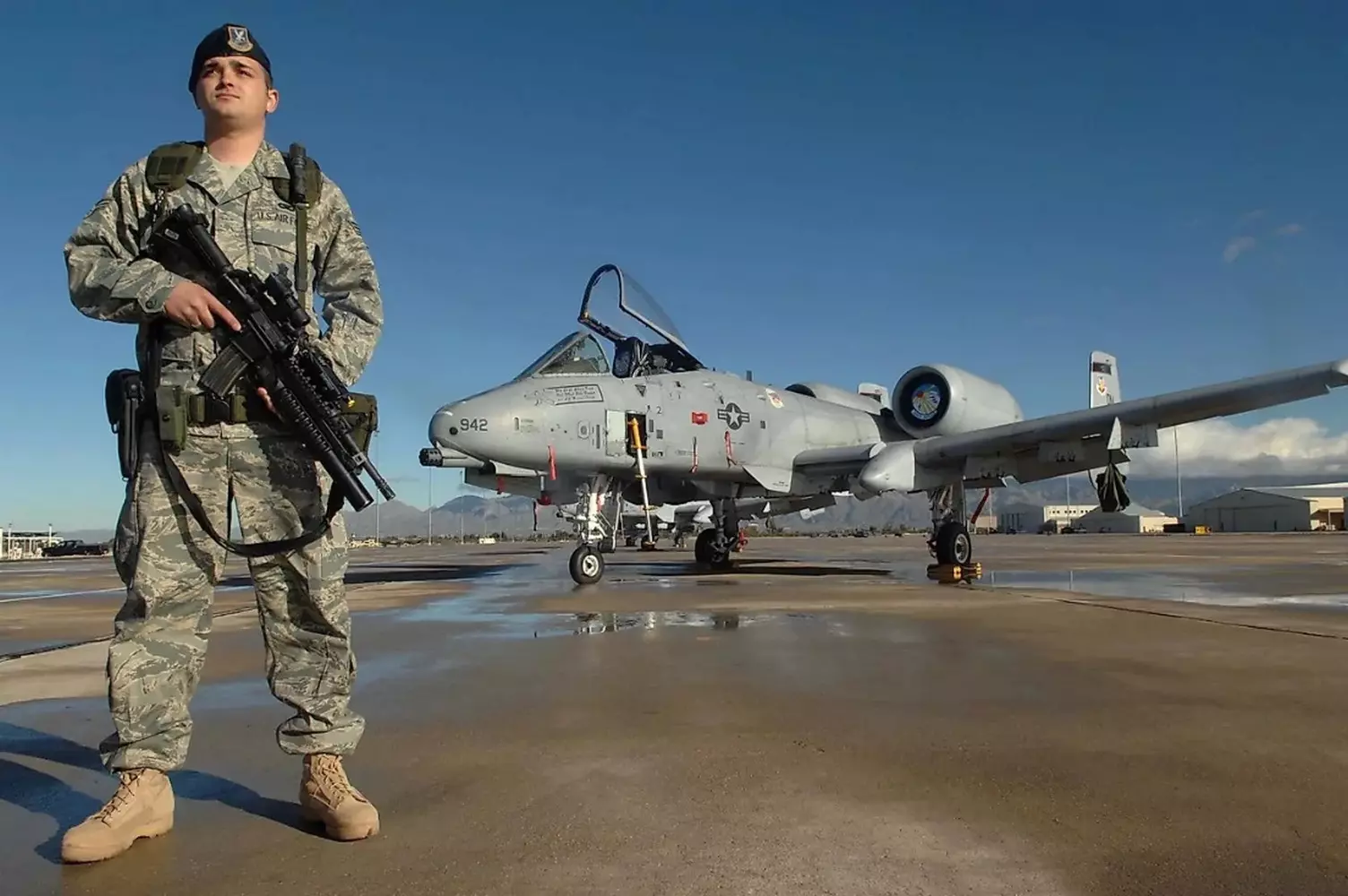 Air Force Pride: A Day in the Life of a U.S. Pilot Portrait of a Smiling U.S. Air Force Officer on the Airfield with an F-16 Fighting Falcon in the Background