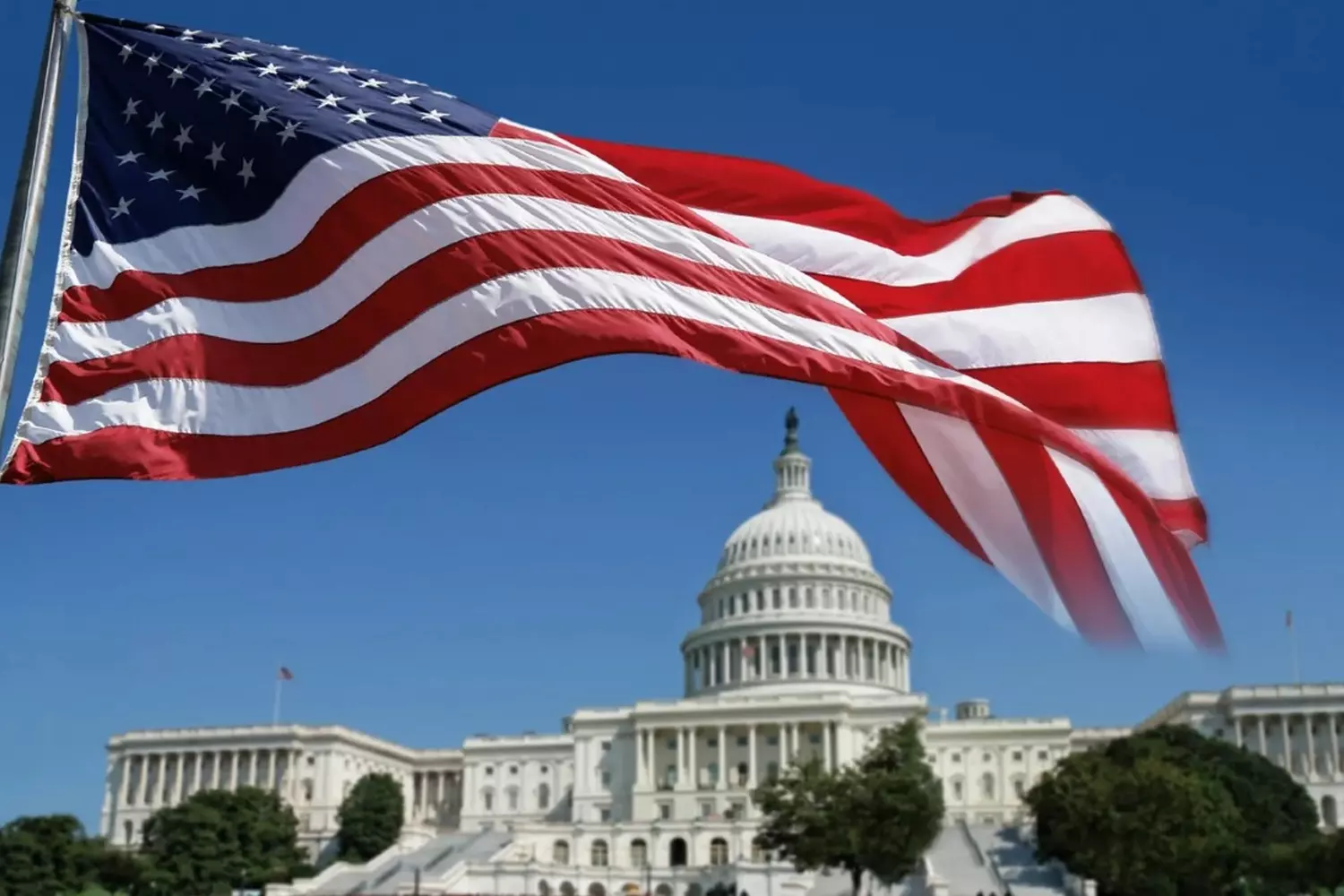 The American flag waving in front of the White House. Symbol of democracy and power The Stars and Stripes of the US flag flying proudly on a flagpole against the backdrop of the White House's north facade and iconic columns