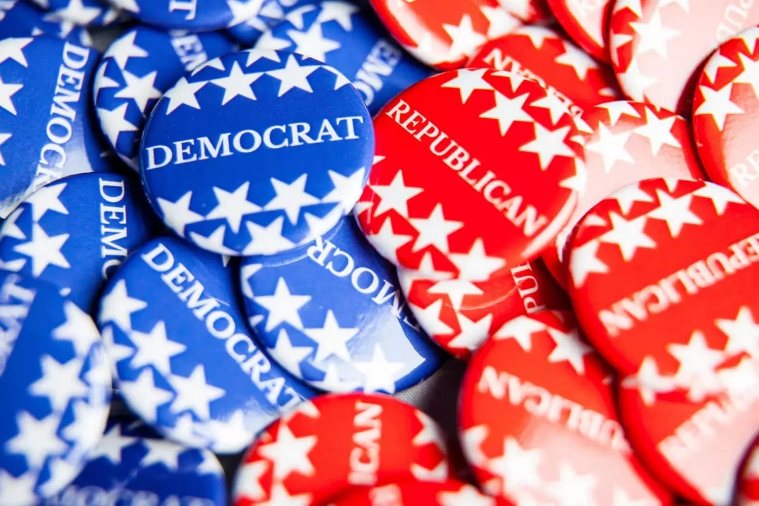 American voter's choice: assortment of Republican and Democratic party pins Multiple campaign pins for the US Republican and Democratic parties displayed together, representing the political choice in American elections