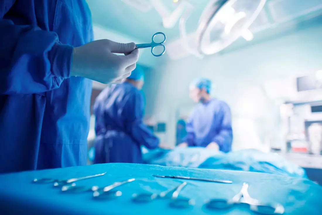 Doctor with scissors in the operating room of a plastic surgery clinic in Miami