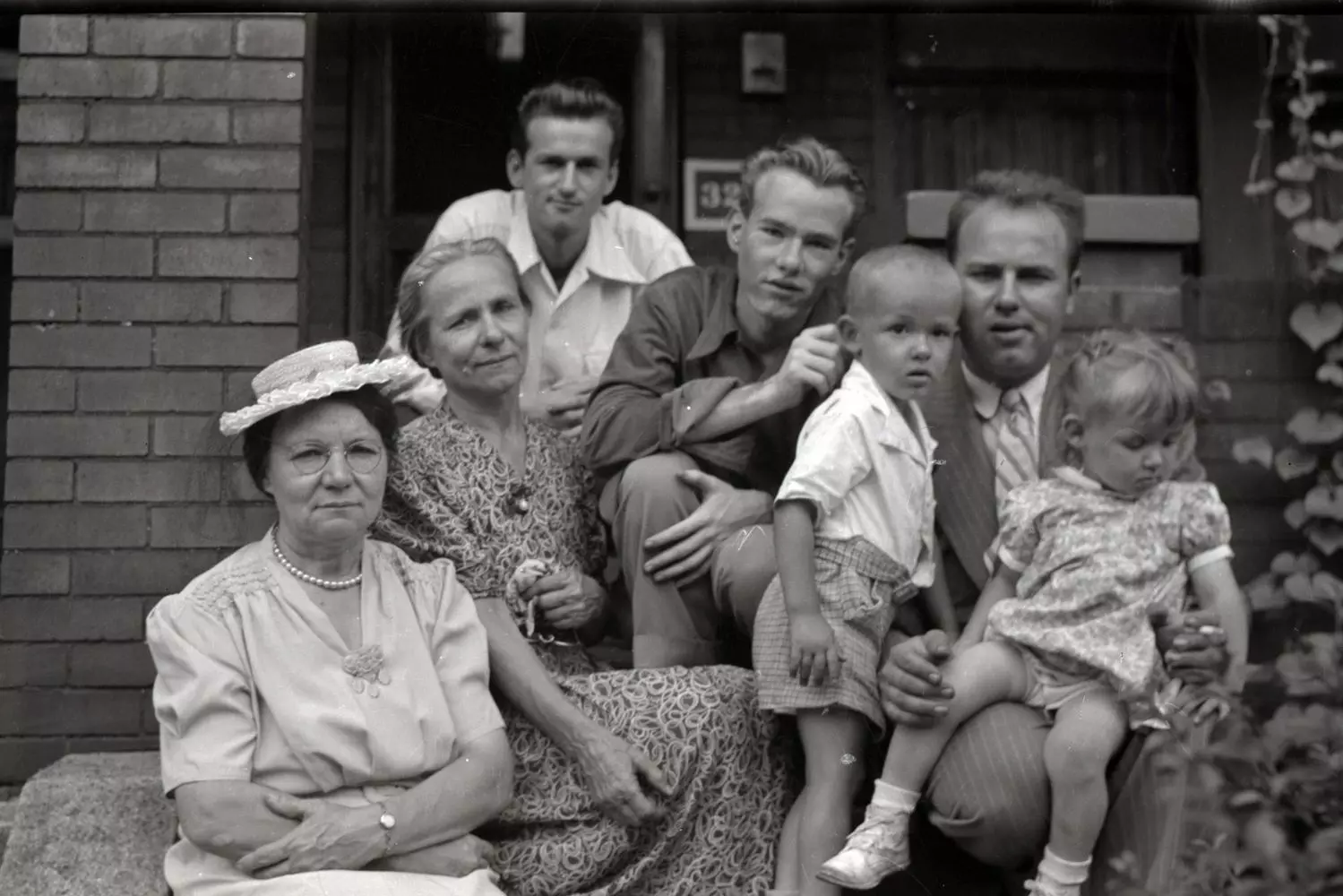 Young Andy Warhol: Rare Childhood Photo With His Immigrant Family A black-and-white vintage photo showing a young Andy Warhol as a child with his Slovakian immigrant parents and siblings in 1930s Pittsburgh, offering a glimpse into his humble beginnings