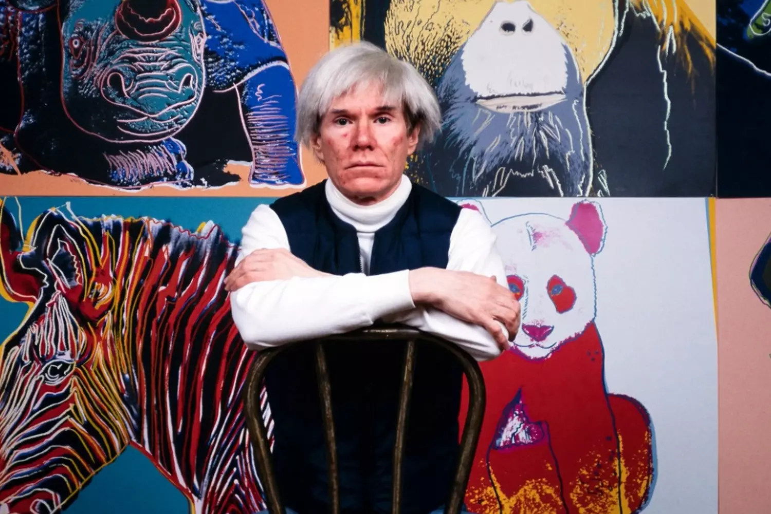 Andy Warhol Among His Masterpieces: The Pop Art Pioneer in His Element Andy Warhol stands pensively in front of his iconic artworks, including Campbell's Soup Cans and Marilyn Monroe portraits, surrounded by the vibrant colors of his pop art legacy
