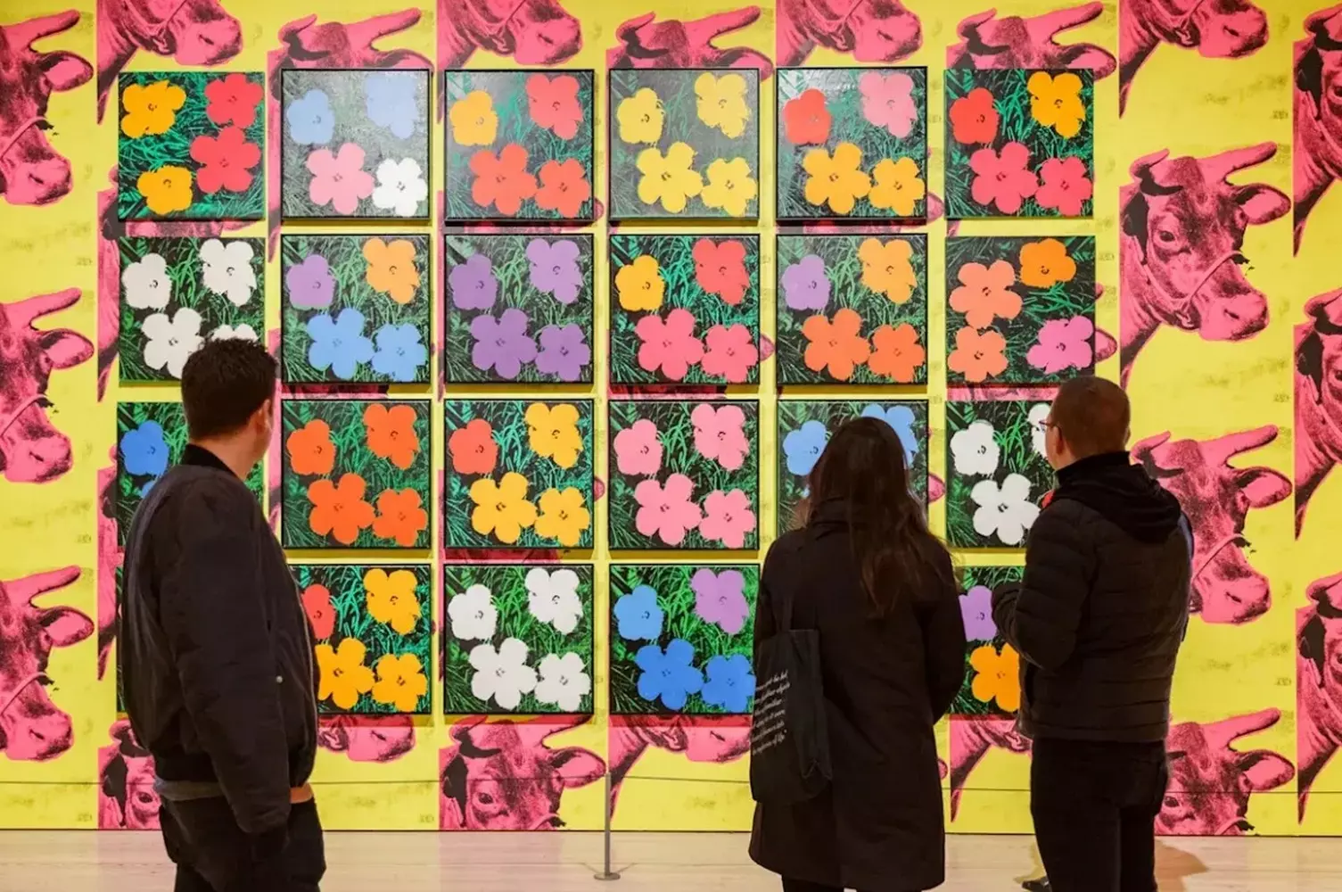 Warhol's Masterpieces on Display: A Museum Showcase of Pop Art Revolution Multiple iconic Andy Warhol paintings exhibited together in a modern museum setting with proper gallery lighting and visitors admiring the works