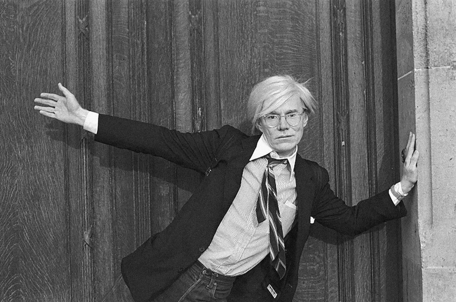 Andy Warhol: The Man Behind the Pop Art Revolution Portrait of Andy Warhol with his signature silver wig and sunglasses, the iconic artist gazes thoughtfully, embodying the spirit of 20th century pop art movement he pioneered