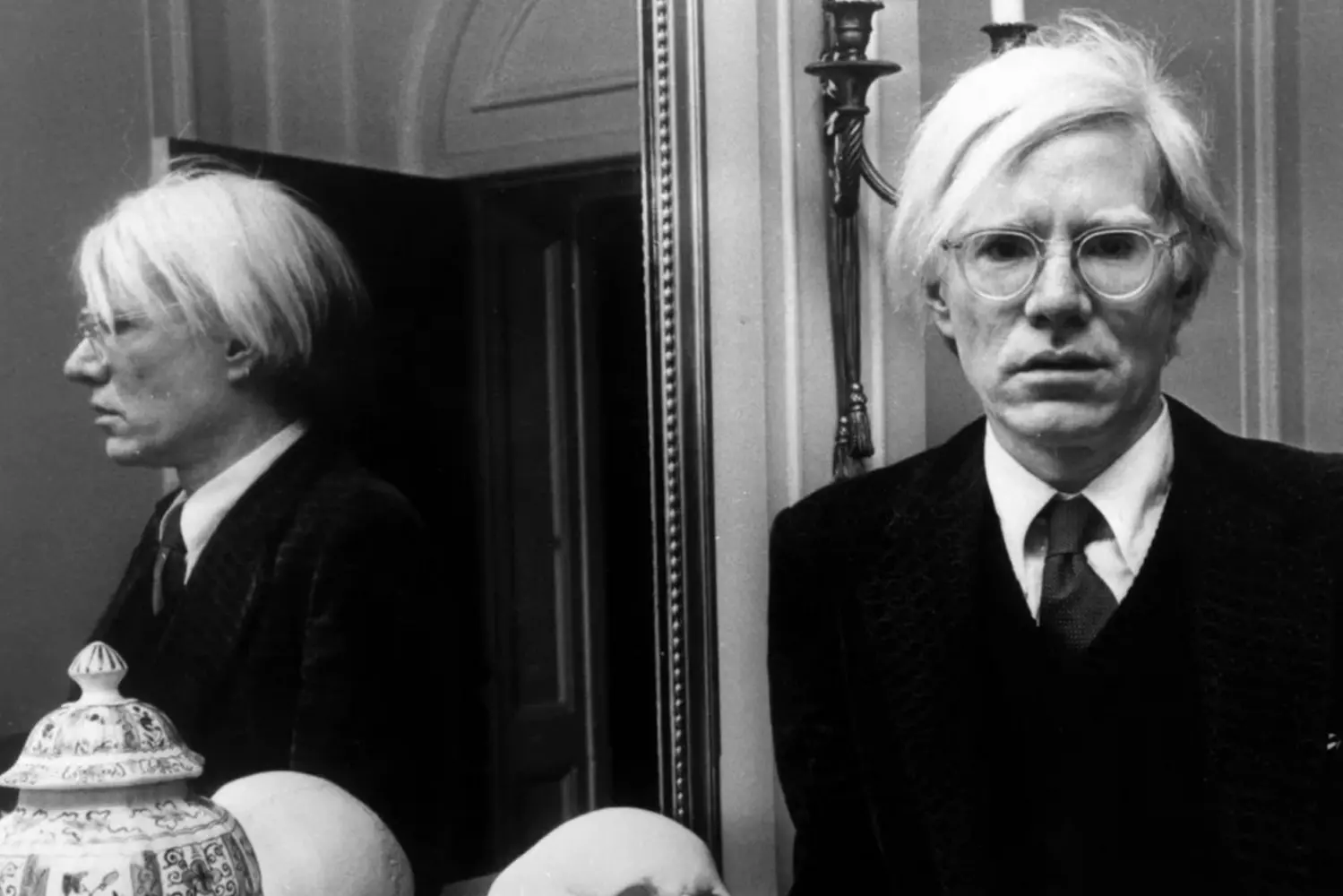 Andy Warhol: The Man Behind the Pop Art Revolution Portrait of Andy Warhol with his signature silver wig and sunglasses, the iconic artist gazes thoughtfully, embodying the spirit of 20th century pop art movement he pioneered
