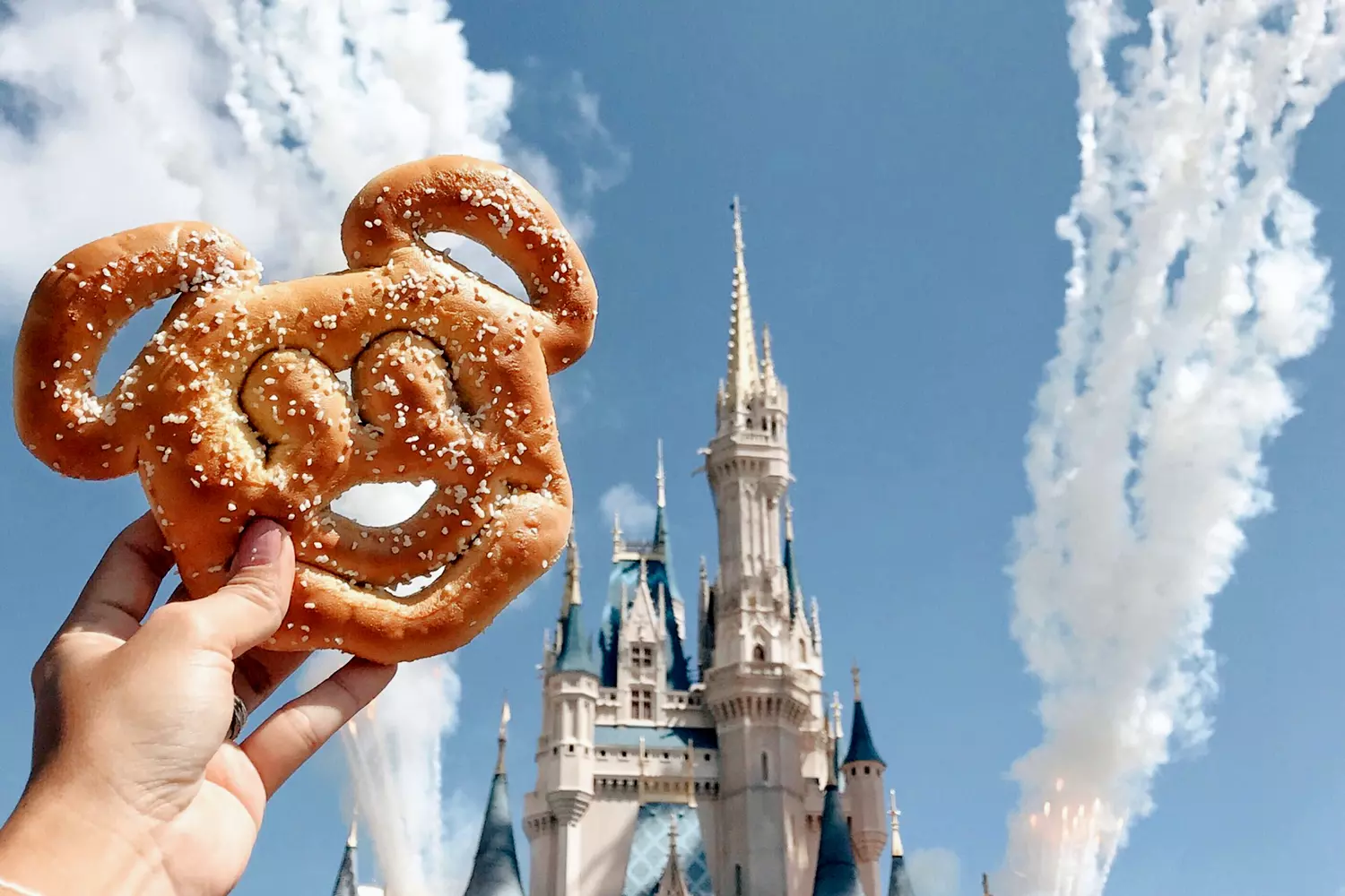 A photo of the symbol of the American animation of Mickey Mouse against the background of Cinderella's castle — Walt Disney Company — American Butler