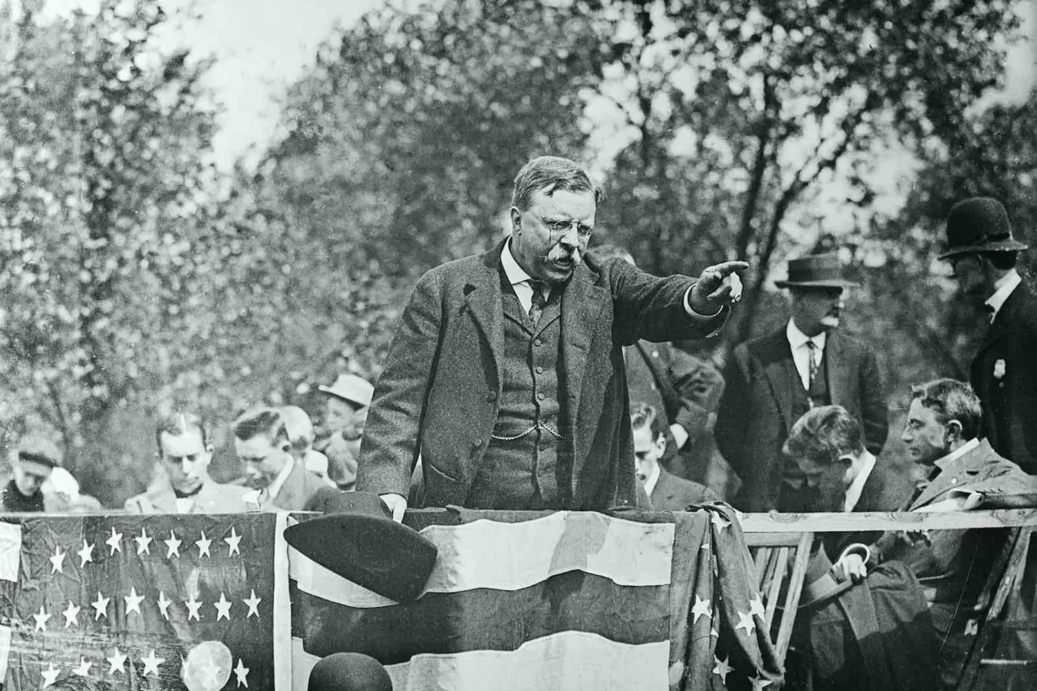 Theodore Roosevelt’s Fiery Speech | The Charismatic Leader Addressing the Crowd Theodore Roosevelt passionately delivers a speech to a large audience, gesturing emphatically