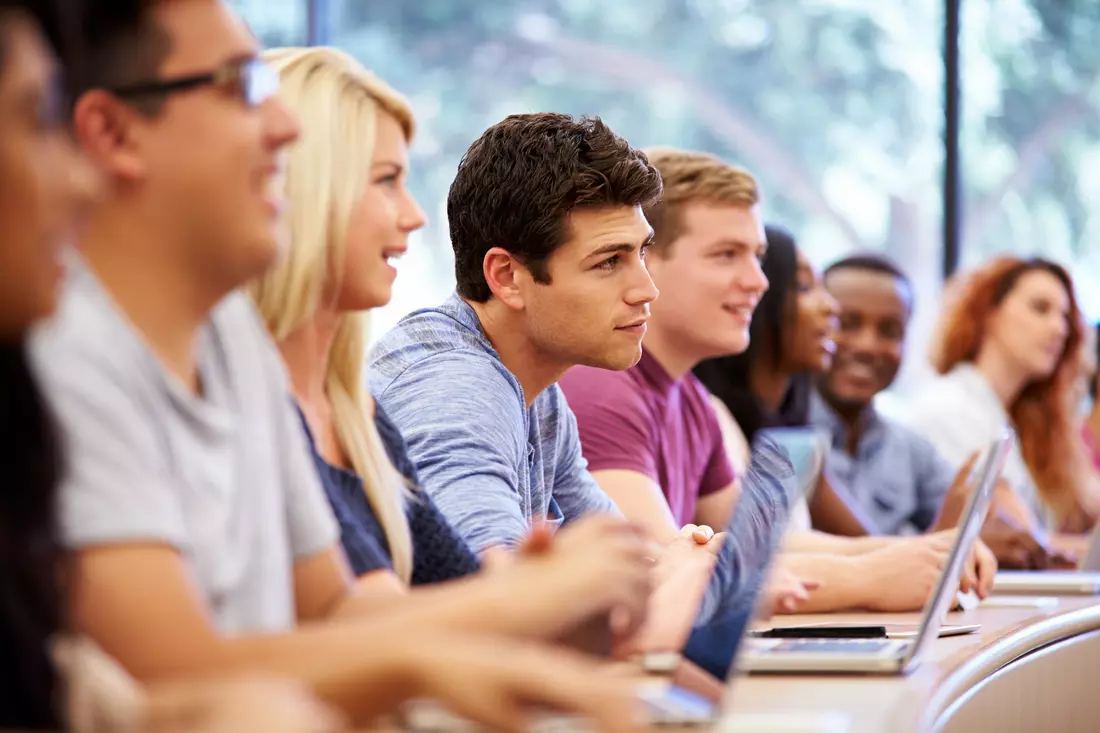 Higher education in the USA — photo of a group of students listening to a lecture at a university — American Butler