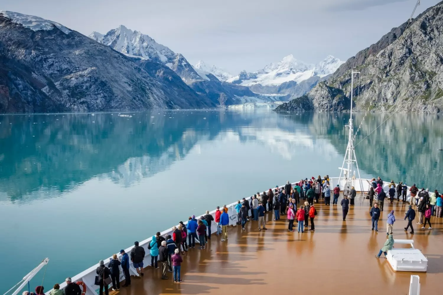 Alaska's Untamed Beauty: Landscapes That Take Your Breath Away Panoramic view of Alaska's rugged wilderness with towering snow-capped mountains, turquoise glaciers, and endless evergreen forests under a dramatic cloudy sky