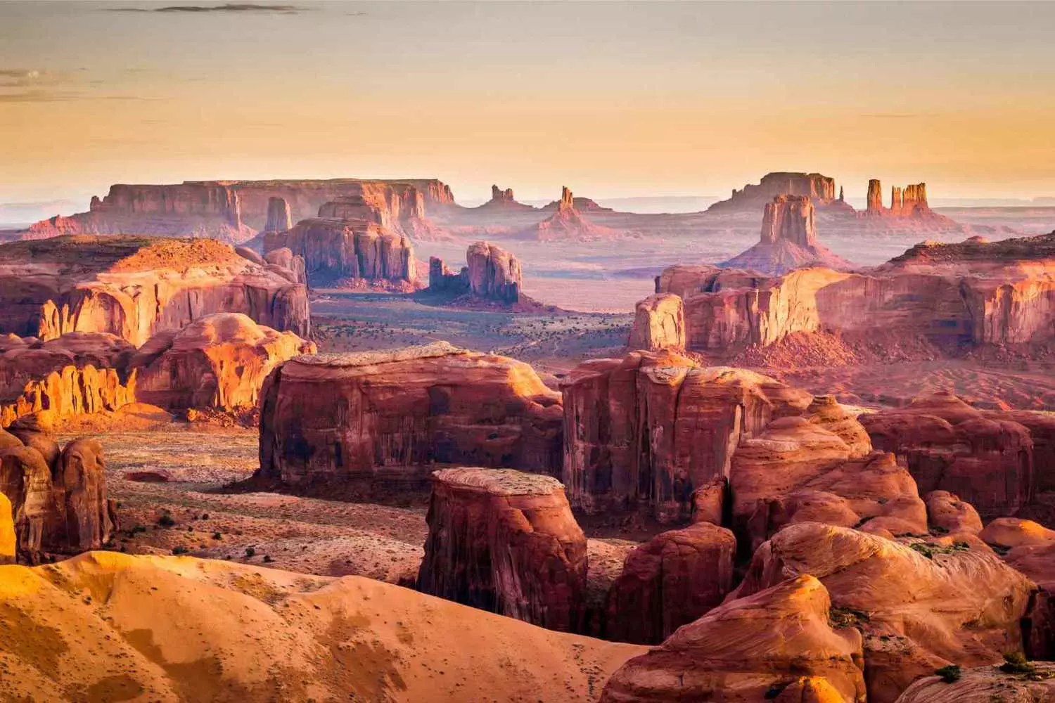 Monument Valley, Arizona: Where the Land Meets the Sky The famous red rock towers of Monument Valley, rising above the Arizona desert beneath dramatic clouds, create a classic Wild West landscape