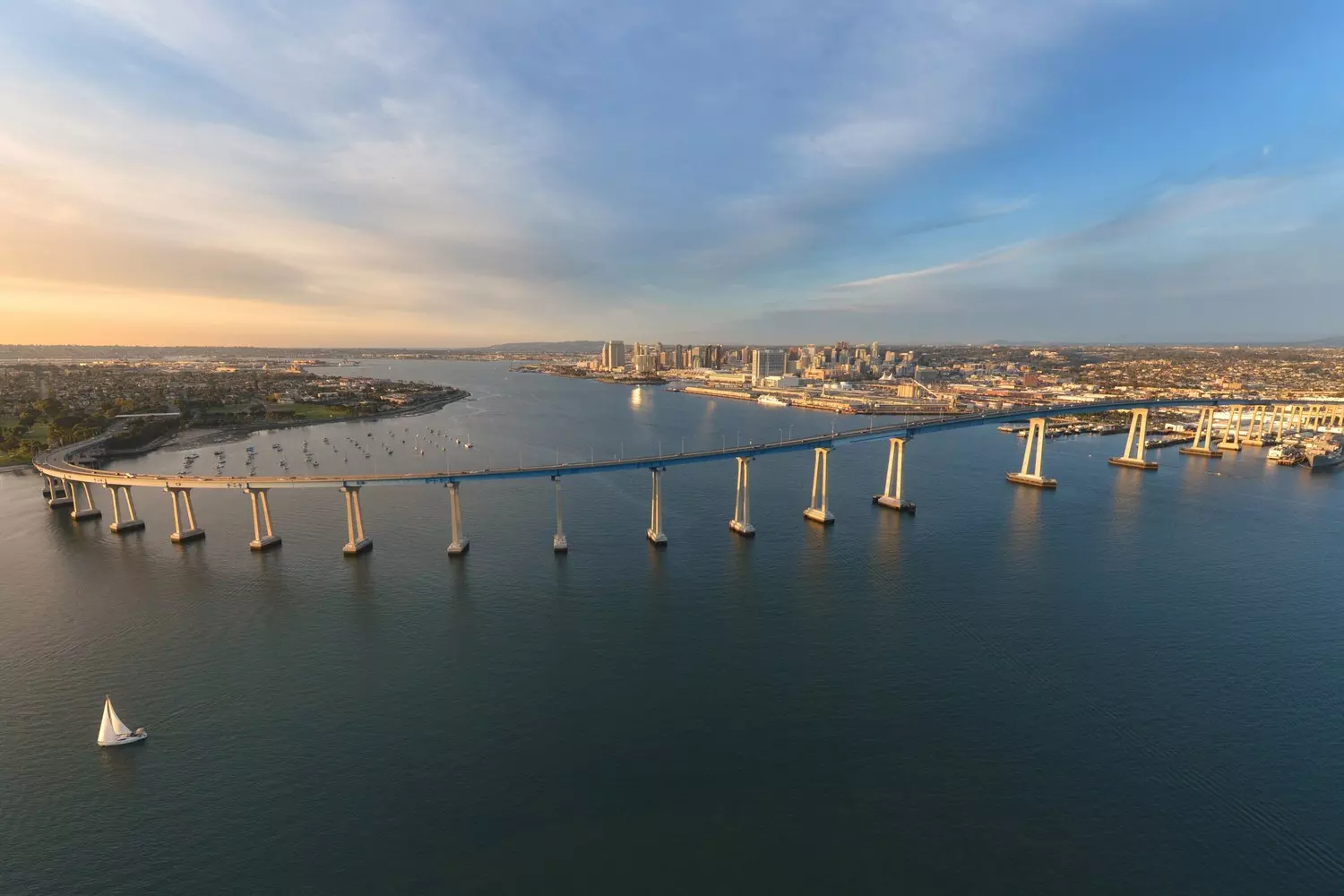 Curved Coronado Bridge in San Diego during the day, panorama of the bay, naval base and scenic coastline