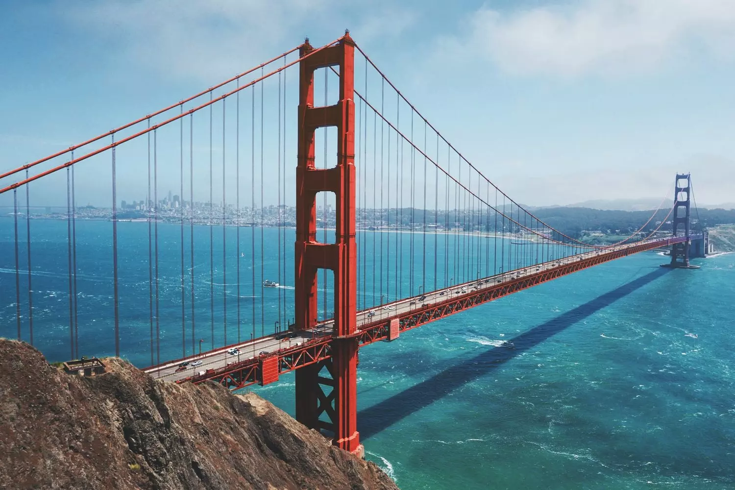 Iconic Golden Gate Bridge in San Francisco during the day, view of the orange towers and the bay