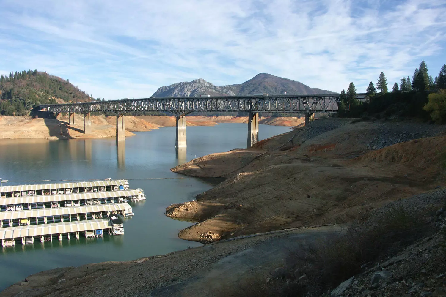 Double-deck Pit River Bridge over Shasta Lake in California during the day, view of steel trusses and blue water