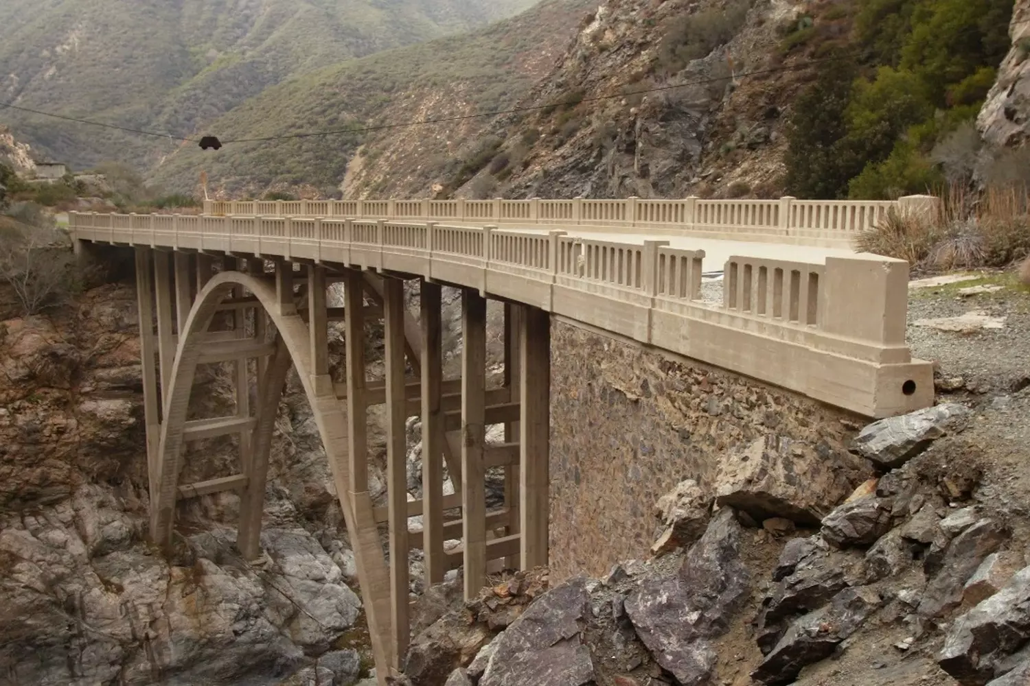 Famous Bridge to Nowhere in the San Gabriel Mountains, California, during the day — concrete arch in the middle of a wild canyon