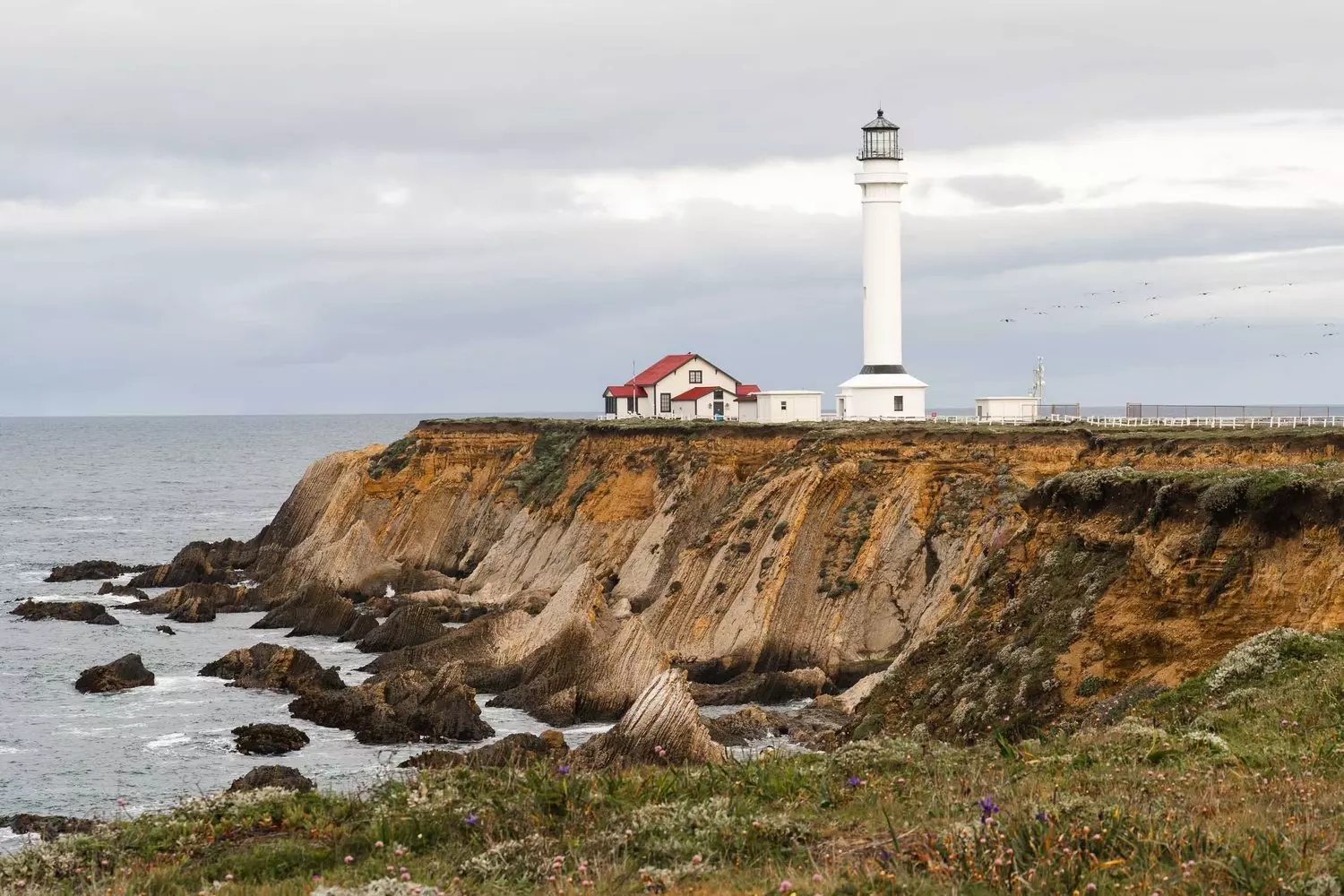 Point Arena Lighthouse, white cylindrical tower 115 feet tall on the California coast