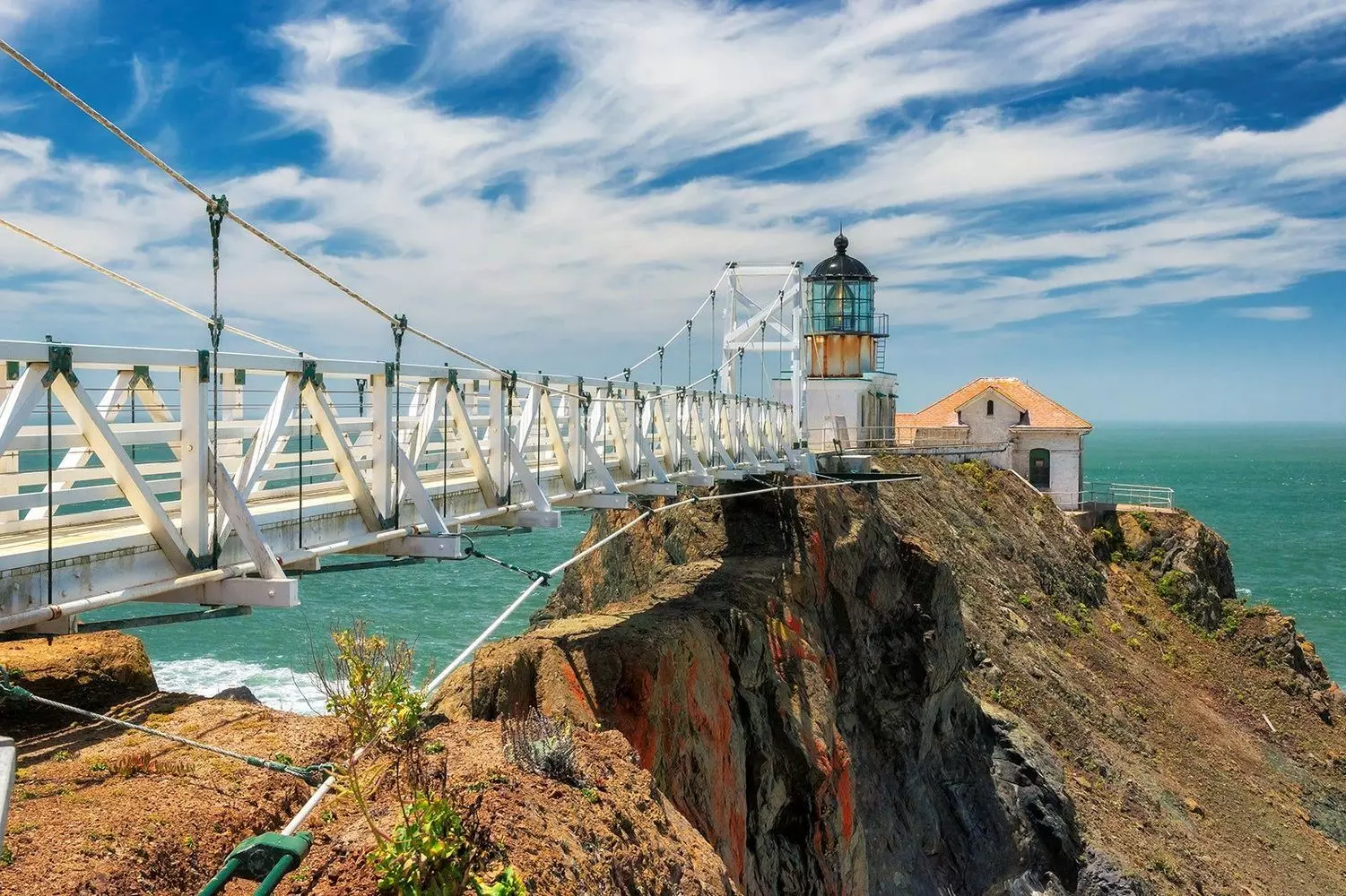 180-foot suspension bridge leading to Point Bonita Lighthouse over the churning surf, California