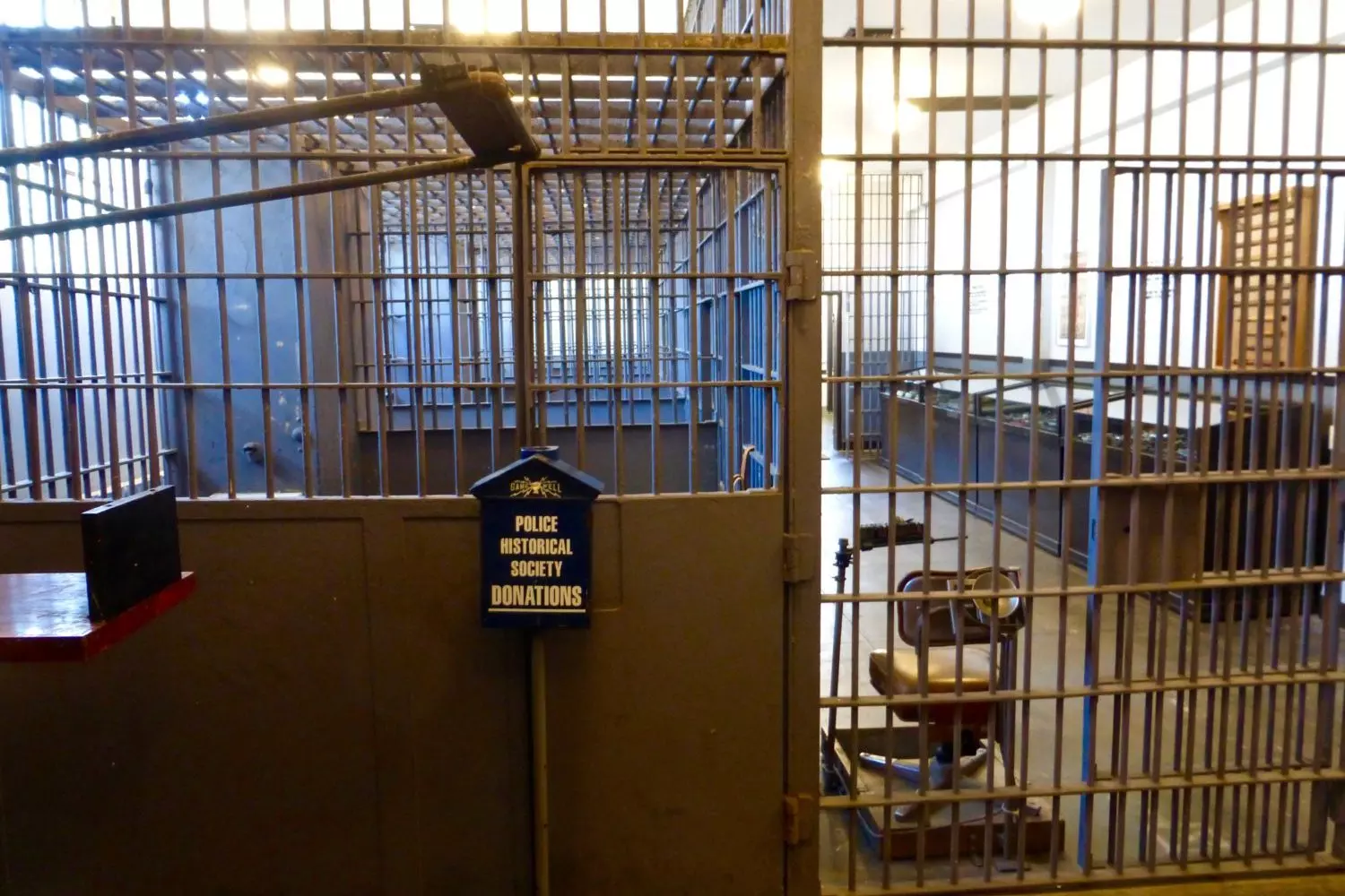 Historic jail cells with bars and bunk beds inside the Los Angeles Police Museum (former LAPD station No. 11)