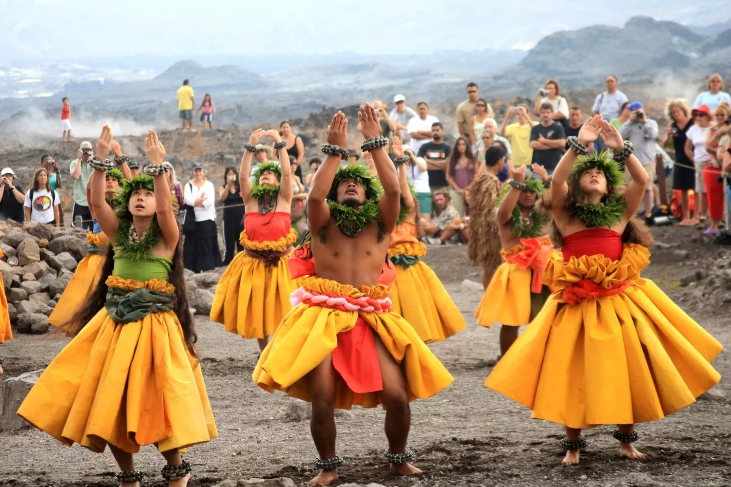 Traditional Hawaiian Hula Dance Performance at Luau Festival A group of dancers in authentic Hawaiian costumes, including grass skirts (pāʻū) and flower leis, performing a hula dance outdoors during a traditional luau celebration