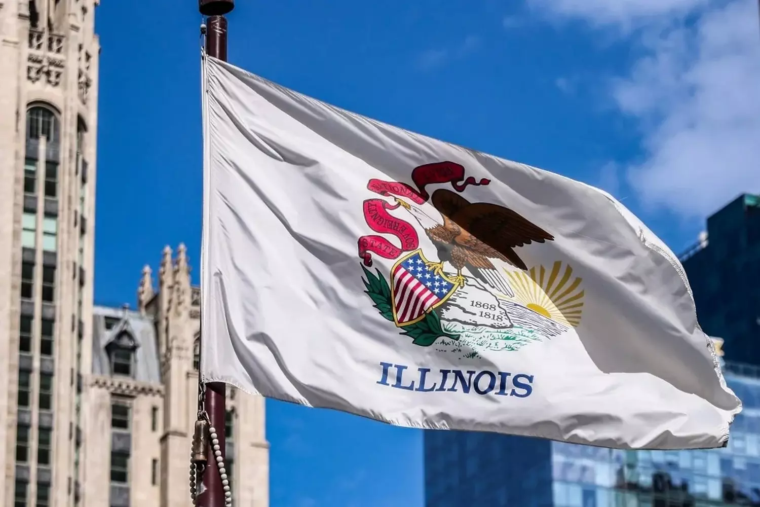 The Illinois Flag: Unfolding the Meaning Behind the State Symbols Close-up of the Illinois state flag featuring the white field with the state seal depicting an eagle holding a banner with state motto 'State Sovereignty, National Union' and dates 1818 and 1868