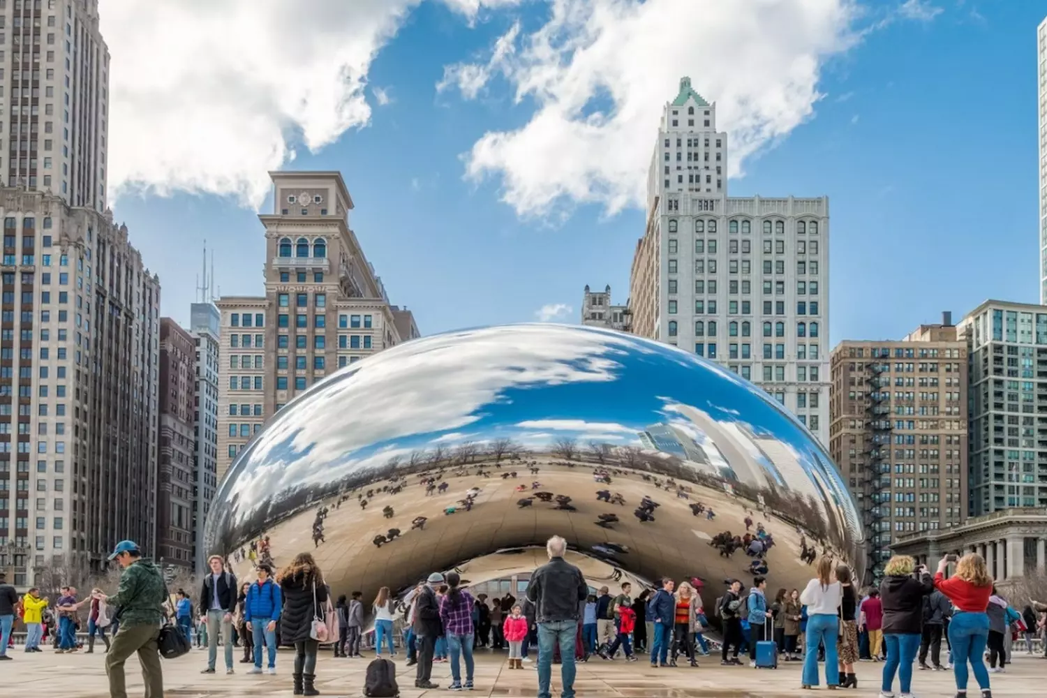 Cloud Gate in Chicago: The Shining Heart of Illinois Iconic Cloud Gate sculpture (The Bean) in Chicago's Millennium Park, reflecting the city skyline and visitors on its polished stainless steel surface under blue skies