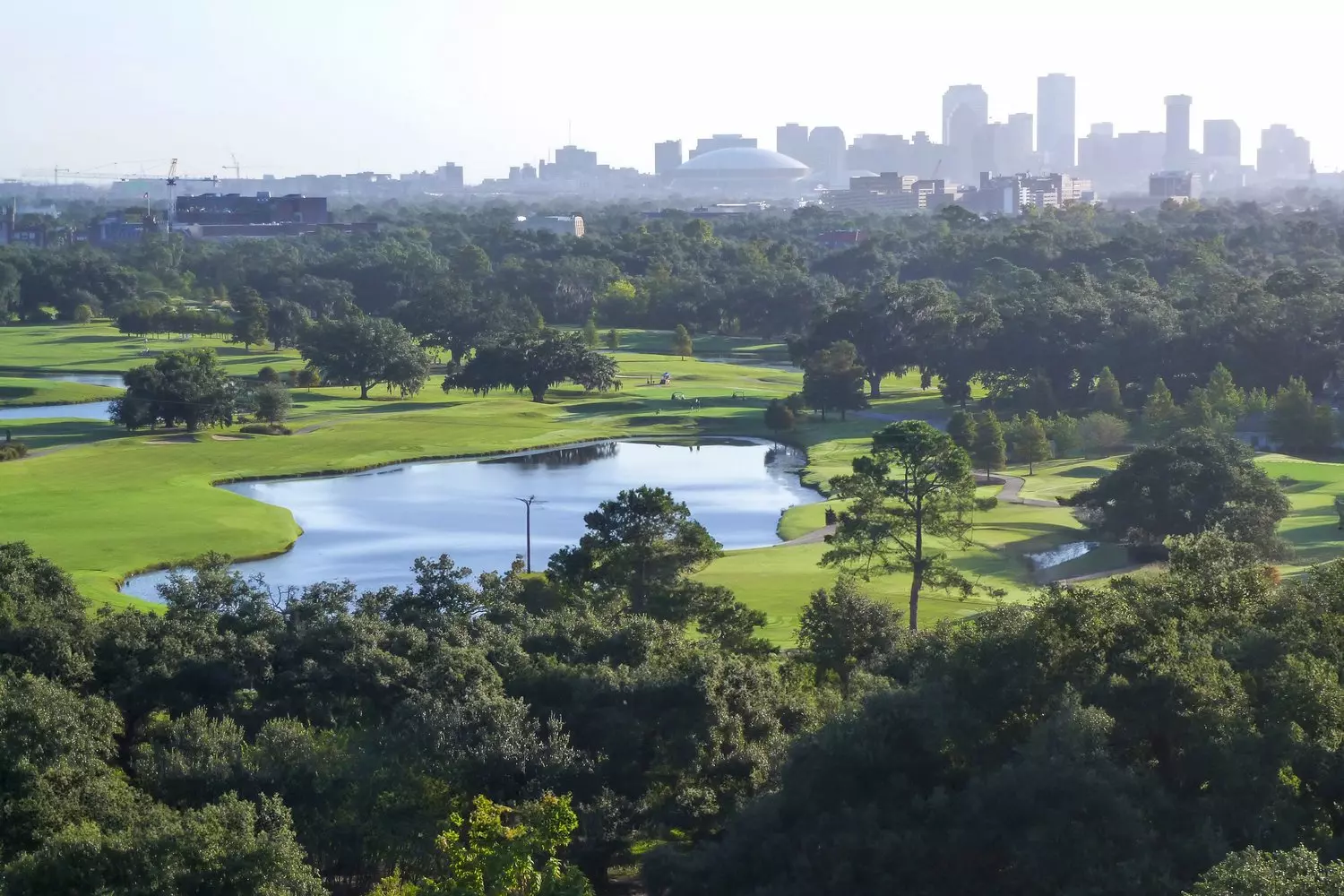 Bird's-eye view of Audubon Park in New Orleans with winding lagoon, green lawns and avenues