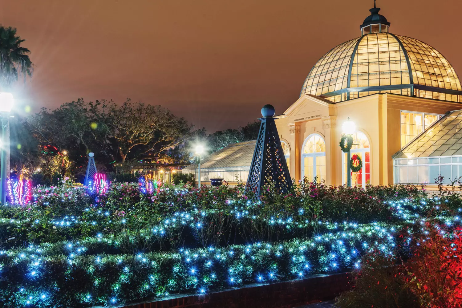 Christmas lights festival Celebration in the Oaks at New Orleans Botanical Garden: trees decorated with thousands of colorful light strands and glowing arches, Louisiana