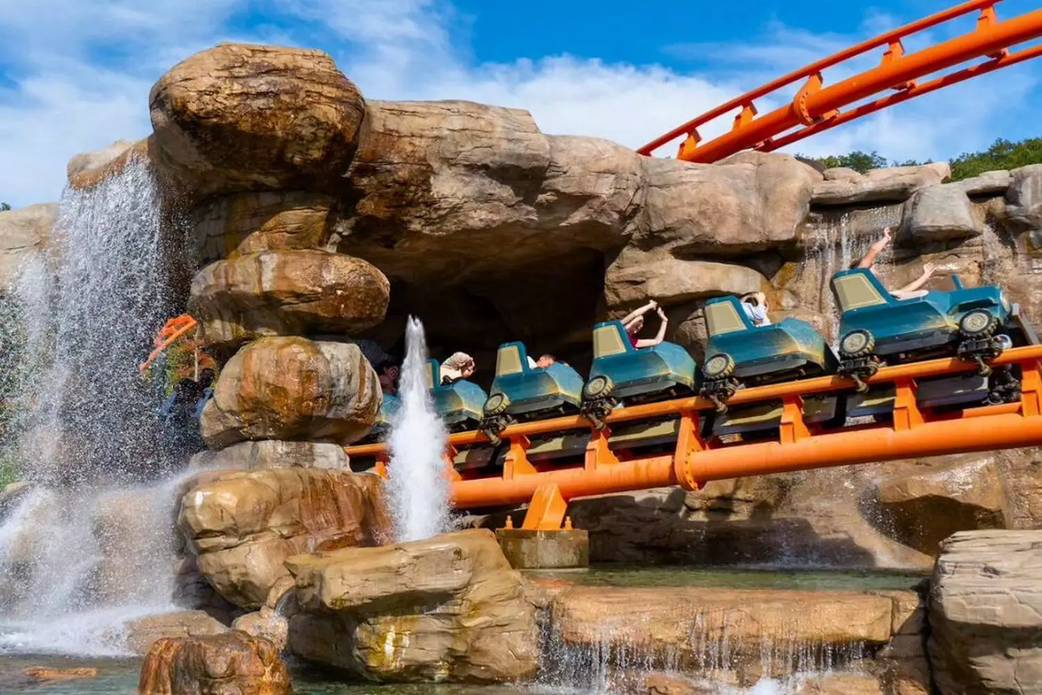 Mountain High Thrills: Dollywood's Legendary Roller Coasters Wooden roller coaster winding through the scenic Smoky Mountains at Dollywood theme park, with riders cheering as the train speeds through sharp turns and drops