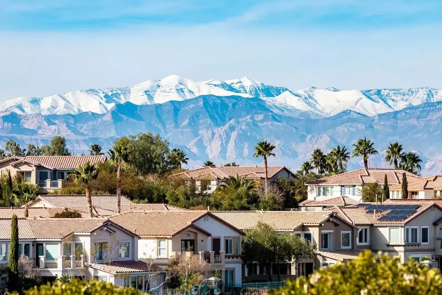 Houses with snow-covered Nevada mountains in the background Scenic view of homes against the snowy peaks of Nevada