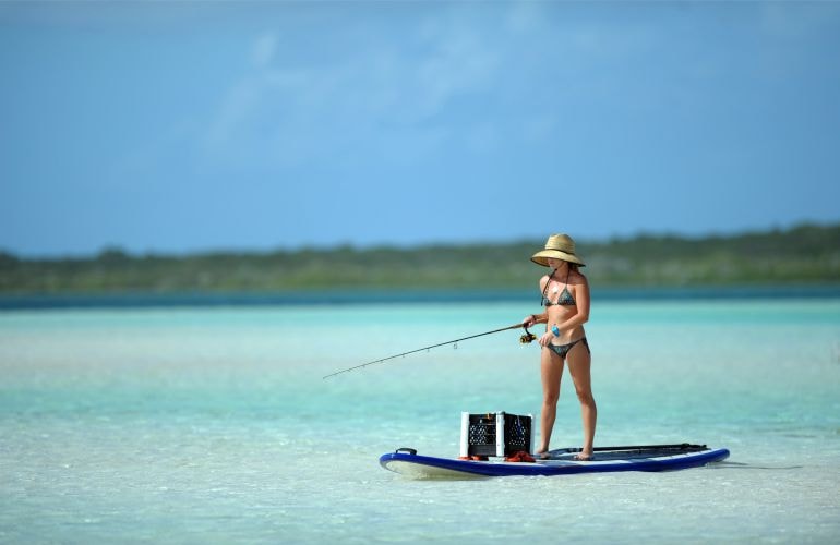 Fishing in the USA — photo of a girl on a paddle board — American Butler