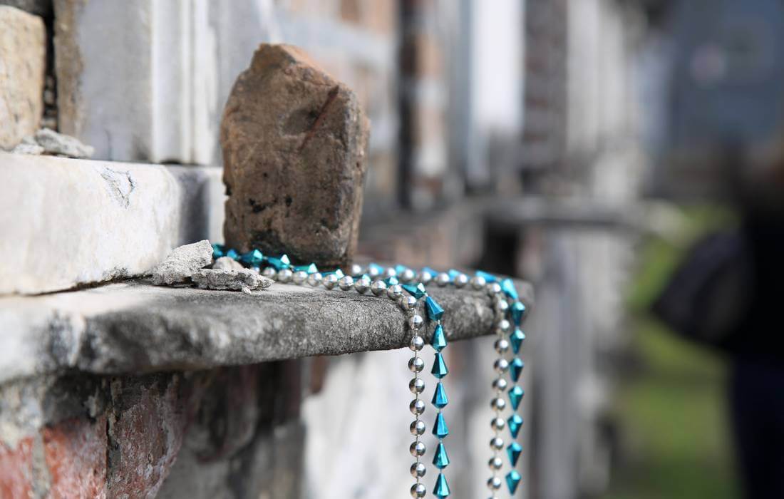 Photo of beads near the tomb of Marie Laveau at the St Louis Cemetery cemetery in New Orleans - American Butler