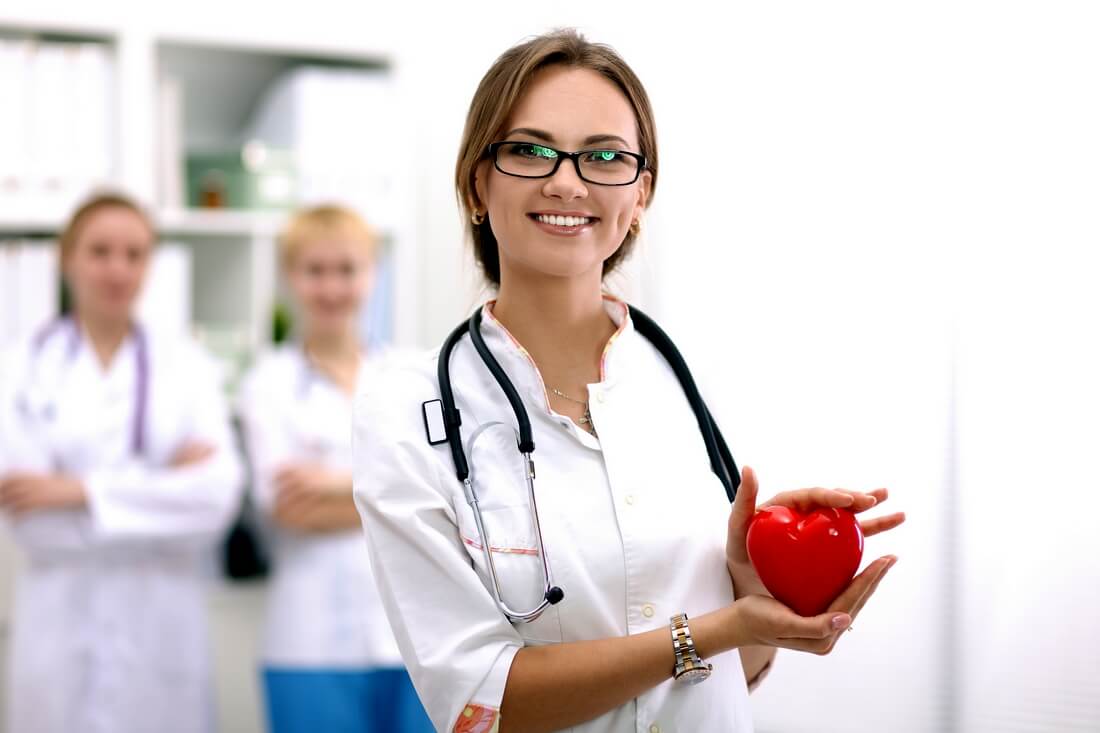 Cardiology in the USA — photo of a nurse with a mock heart in her hands — American Butler