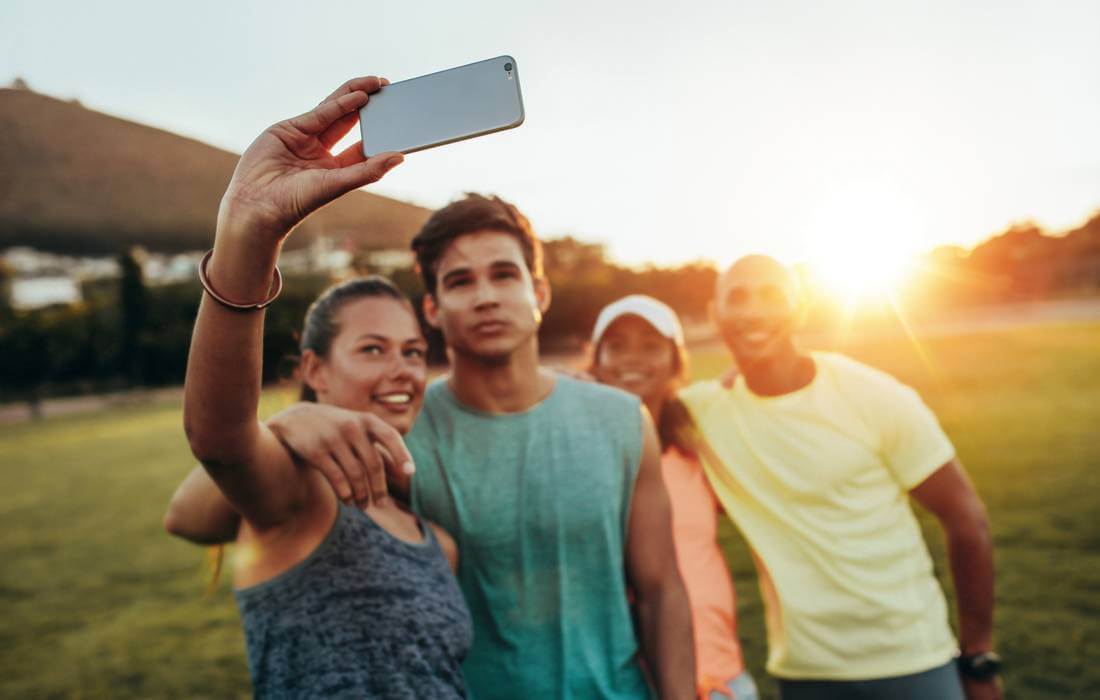 Cellular and Internet in America - photos of young people taking selfies on their mobile phones - American Butler