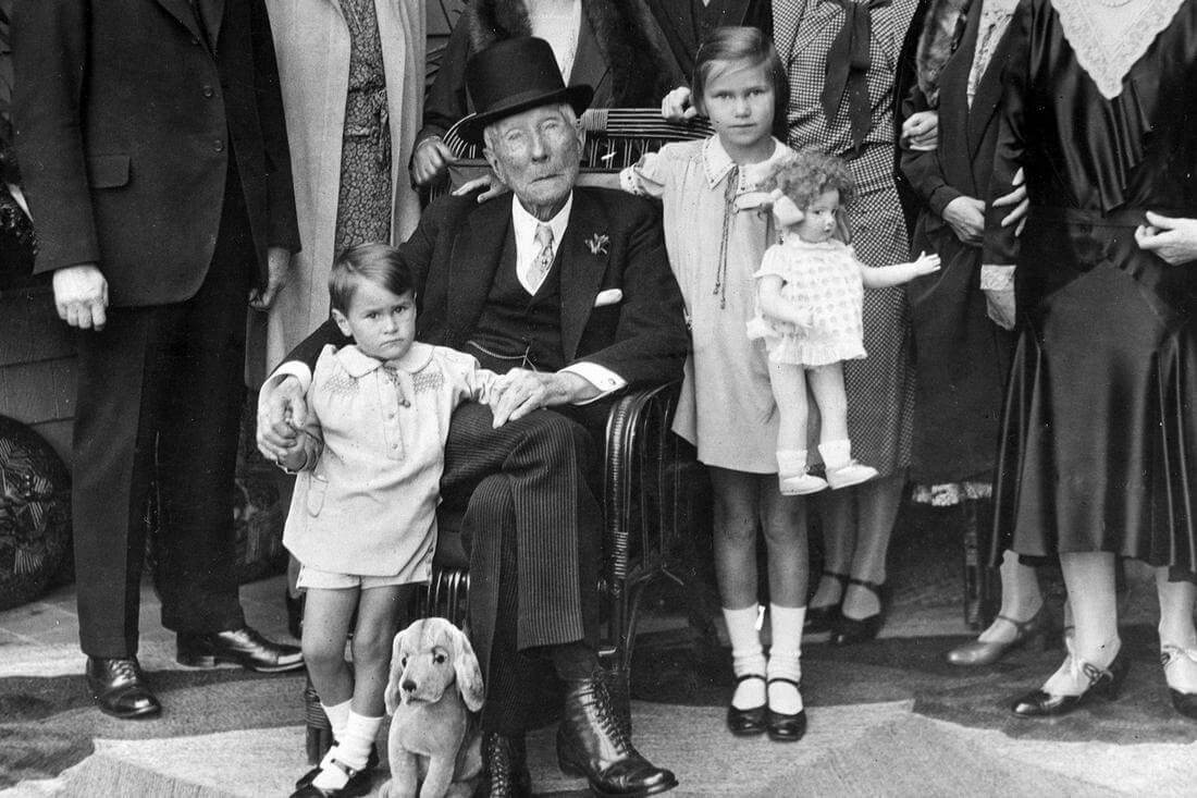 Black and white photo of John Rockefeller with family and children — American Butler